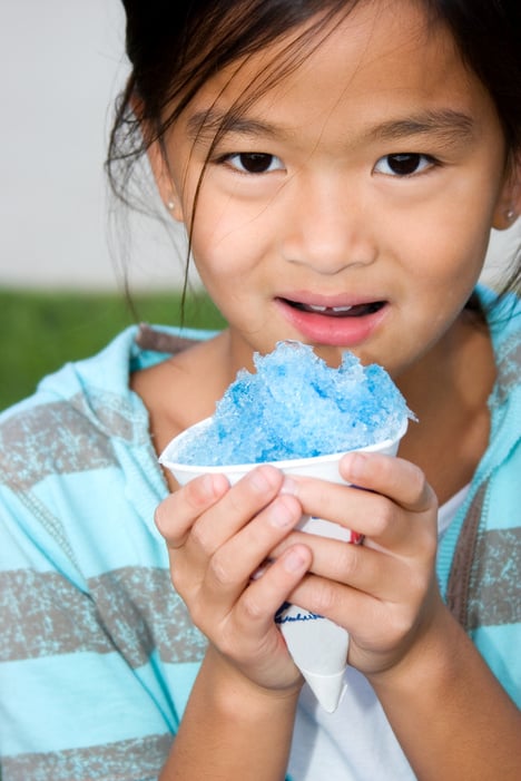 Chinese child with blue snow cone